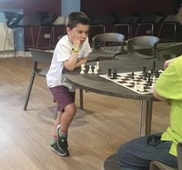 8 year old Ethan Cole wins simul at Greenisland FC with score of 16-0